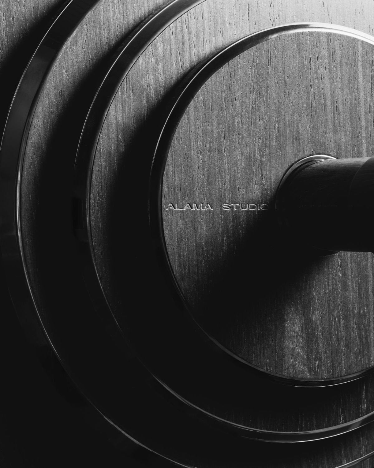Concentric machined rings of an Alama plate with the engraved Alama Studio mark.