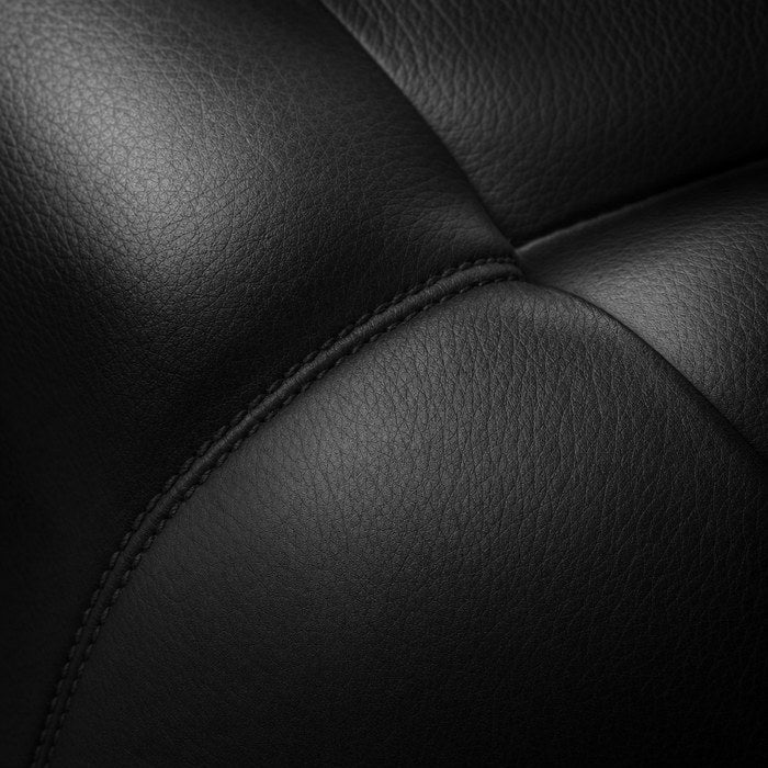 Macro of fine Italian leather with a hand-stitched seam, finished by a century-old tannery.