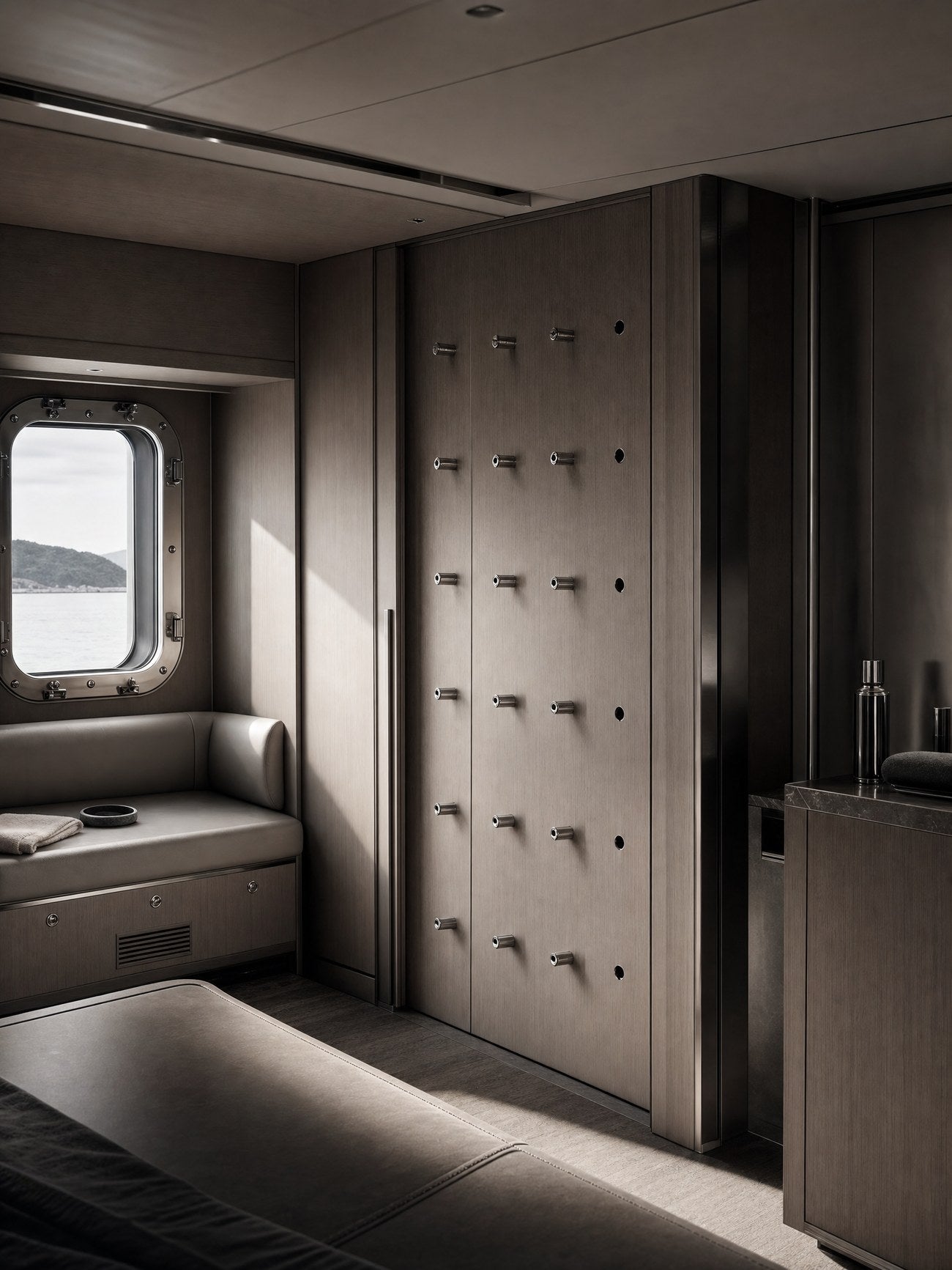 A superyacht cabin during refit, a bulkhead in ALPI wood and marine-grade steel prepared for an Alama wall storage system.